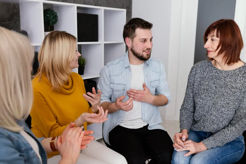 People holding hands in a circle outdoors